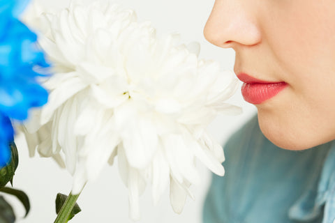 Lady smelling white flower