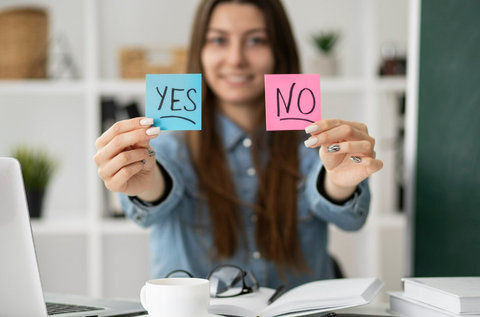 A girl holding a paper with a yes or no note 5