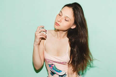 A girl testing a dupe perfume