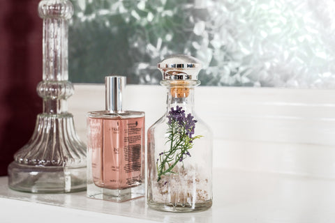 Close-up shot of perfume beside the window