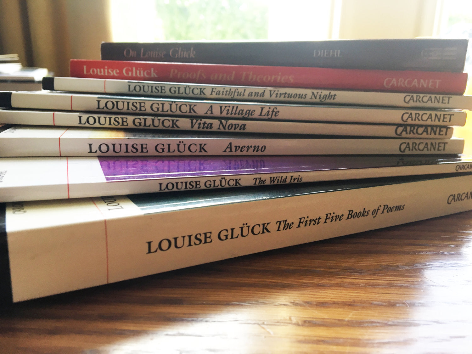 Louise Glück's collection of books via Untwine Me.jpg