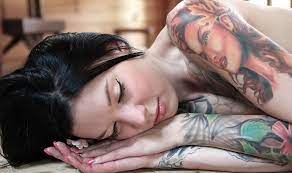 Sleeping woman with tattoos