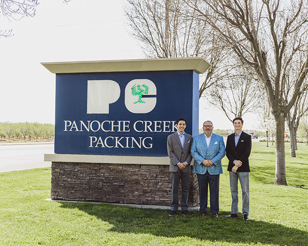 Frank Roque with sons in front of Panoche Packing sign