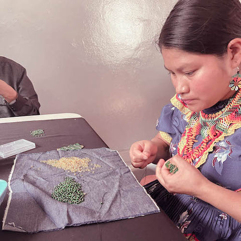 Embera indigenos woman sewing jewelry