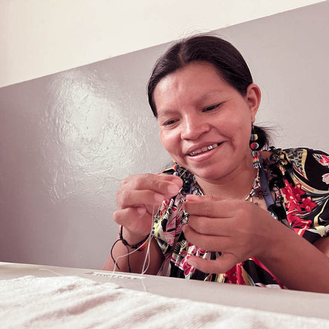 Embera Indigenous woman sewing jewelry