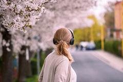 Woman listens to audiobook on a walk