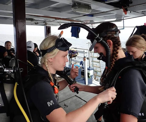 Divers running a check before jumping in the water at Koh Tao, Thailand