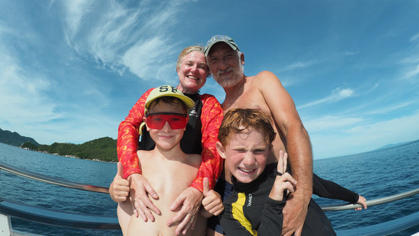 Happy family ready to scuba dive together in Koh Tao, Thailand