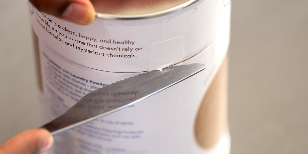 Cut the adhesive tab on the lid using a table knife