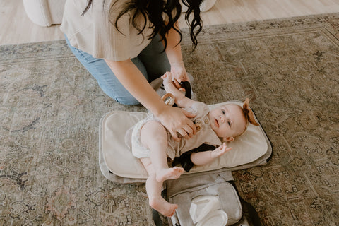 Baby is trying to roll over unstrapped on changing pad