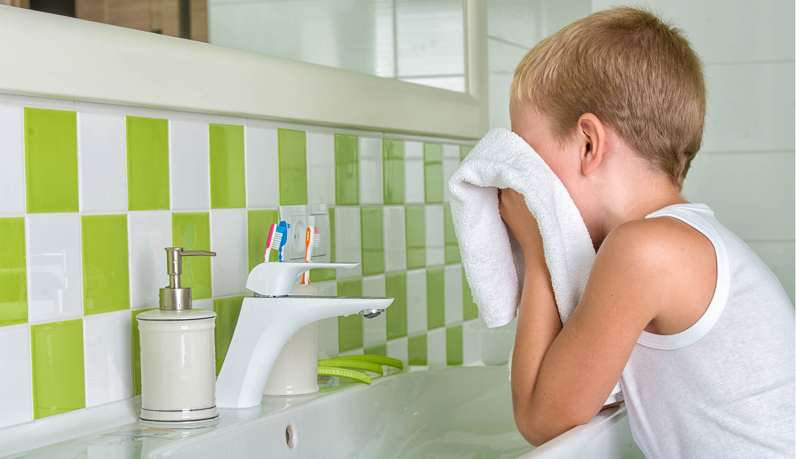 a boy washes his face.jpg