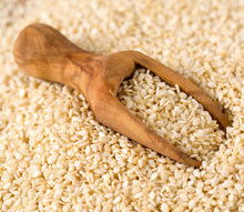 Raw Sesame seed in a wooden container on a jute rug