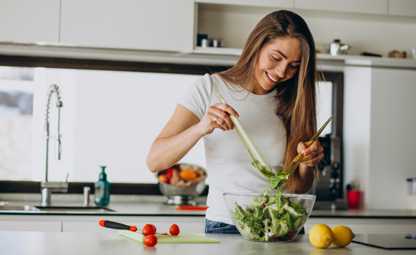A woman making salad in the kitchen