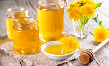 Pure and fresh honey in different containers on a wooden table