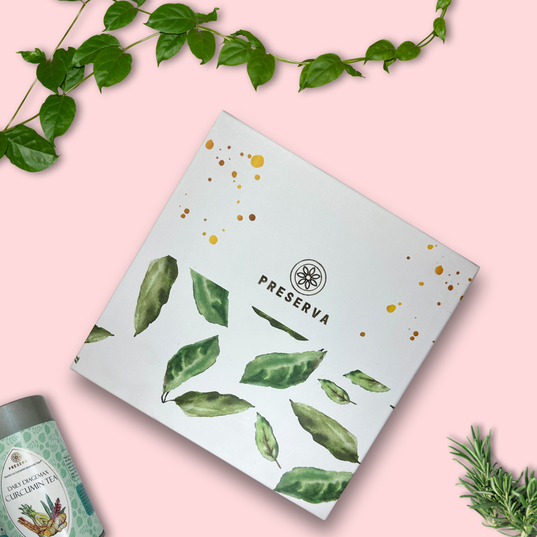 White Tea Gift Box with green leaves pattern on it next to Daily Diagemax Tea