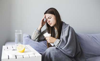 A woman having a headache due to seasonal fever