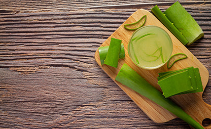 Fresh and organic sliced Aloe Vera and Aloe Vera juice on a wooden tray