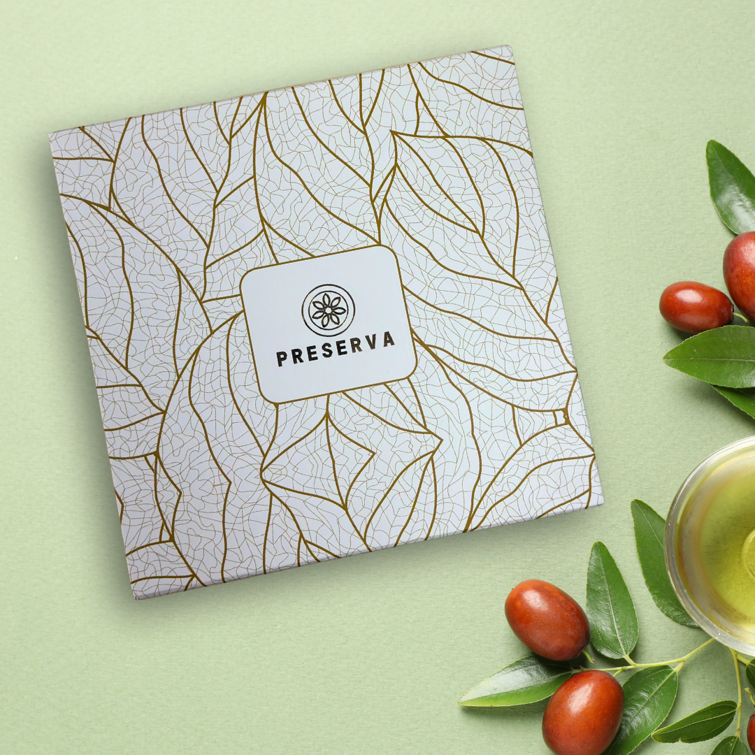 Cream and golden colour Preserva Wellness Tea Gift Box next to fresh berries