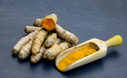 Pure organic curcumin next to a wooden scoop