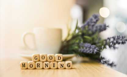 Good morning with a coffee mug and lavenders in the background