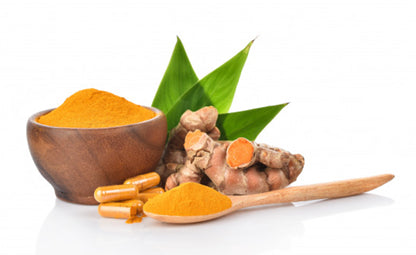 Organic Curcumin and curcumin powder in a wooden bowl next to a wooden spoon and vegan-friendly curcumin capsules