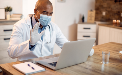 A doctor talking to the patient through video call on a laptop