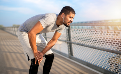  A man holding his knee due to joint pain