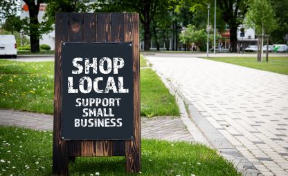 Board of Shop local for small business on a roadside