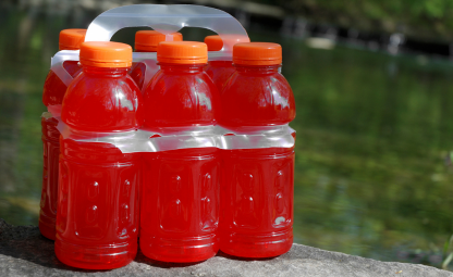 Pack of Orange sports drink bottles with orange caps