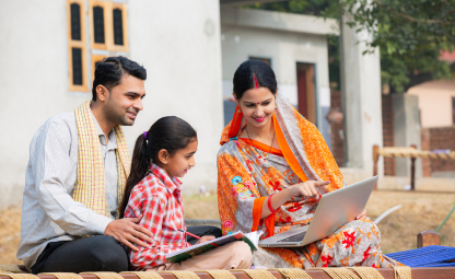 Indian parents teaching their girl child from Laptop