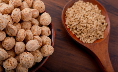 Soya Chunks next to Soya in a wooden spoon