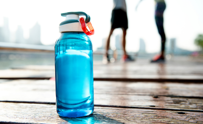 Blue colour plastic sipper on a wooden floor