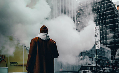 Air pollution and fog in an urban city and a person standing