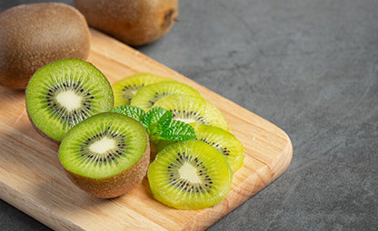 Organic Kiwi and Kiwi slices on a wooden tray