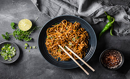 Noodles with chopsticks lime, soy sauce and spring onion