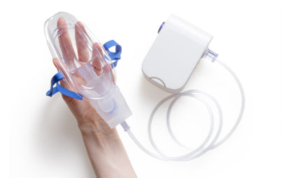 Hand holding respiratory machine’s mask