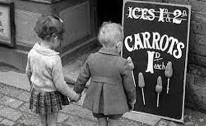 Two kids holding hands and looking at carrot board in black and white