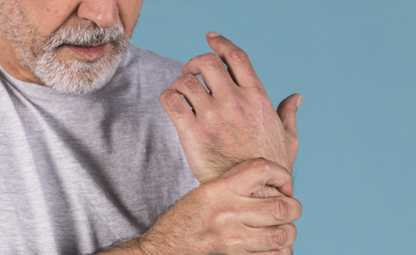 A person having arthritis joint pain in his hand