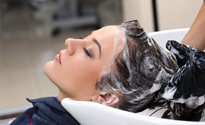 A woman getting a hair wash done at a parlour