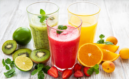 Sliced avocados, strawberries, and oranges with healthy fruit juices