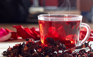 Hibiscus Tea with dried Hibiscus leaves around it