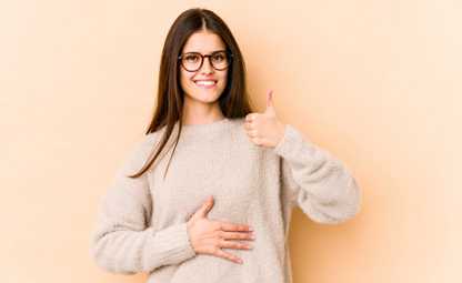 A woman doing thumbs up due to good gut health