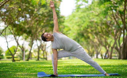 A man doing testosterone-boosting yoga pose in a park
