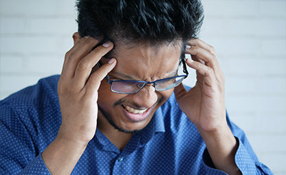 A man holding his head with headache and stress