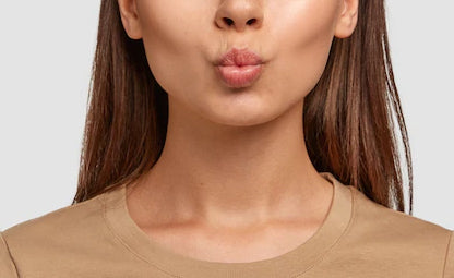 A woman making a pout face for a breathing exercise
