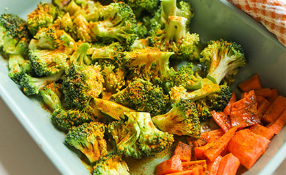 Spiced broccolis and carrots in a blue container