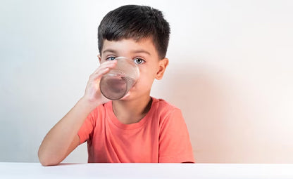 Child drinking a glass of water