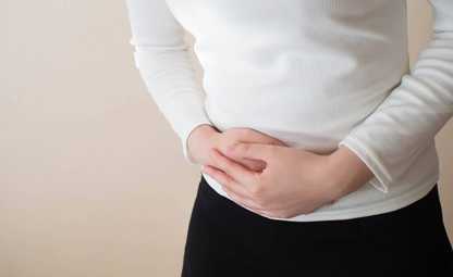 A person having stomach pain due to PCOS/PCOD