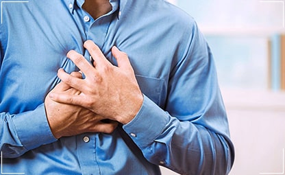 A person holding his chest due to a heart attack