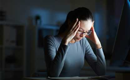 Woman being stressed and tensed putting hands on her head

